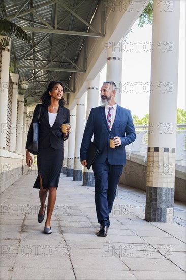 Business people walking on sidewalk