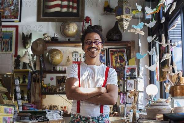 Smiling mixed race man wearing suspenders