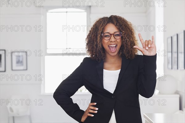 Mixed race woman gesturing in gallery