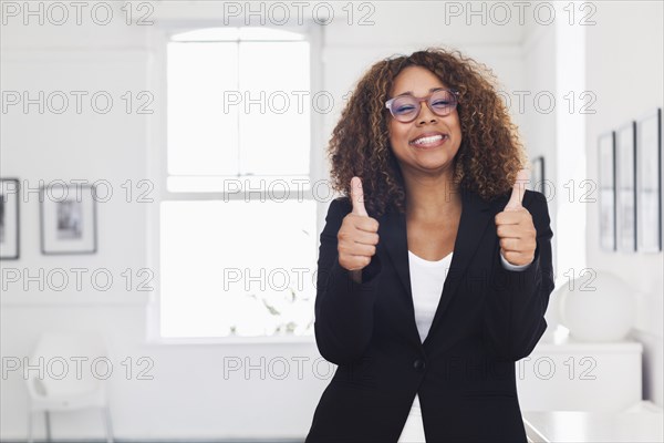 Mixed race woman gesturing in gallery