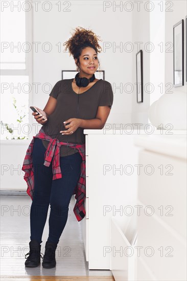 Mixed race woman holding cell phone