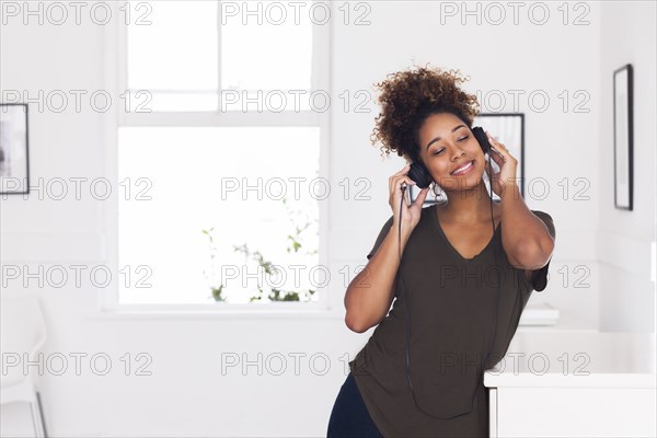 Mixed race woman listening to headphones