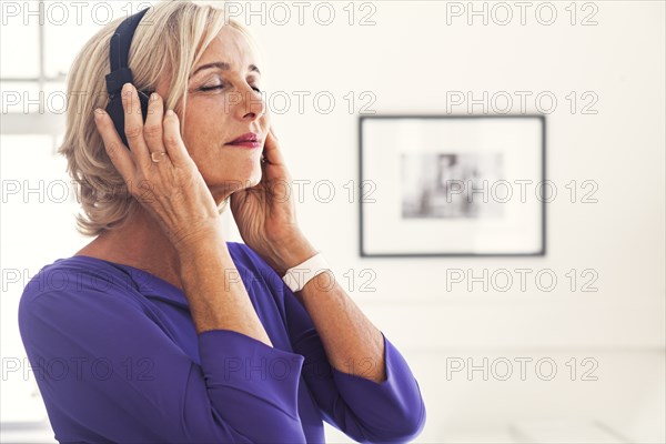 Caucasian woman listening to headphones