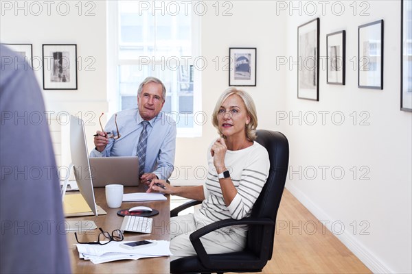 Caucasian business people talking at table