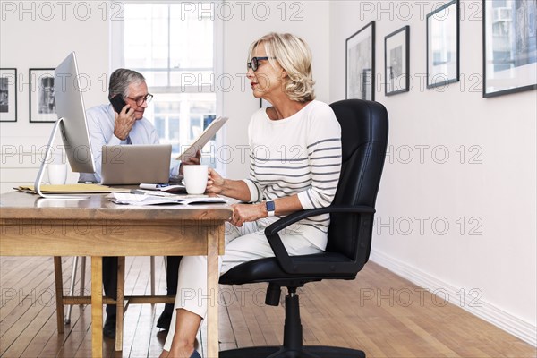 Caucasian business people working in gallery