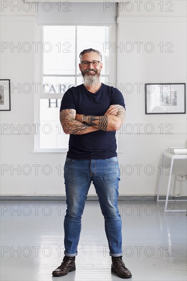 Portrait of smiling muscular Caucasian hipster man