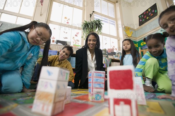 Multi-ethnic students in classroom with teacher