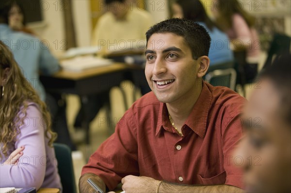 Asian student listening to teacher in classroom