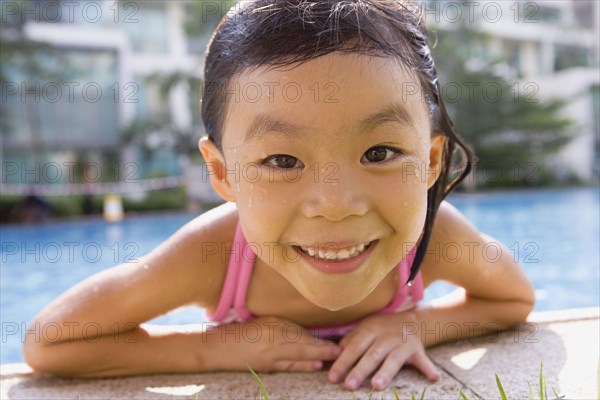 Asian girl getting out of swimming pool