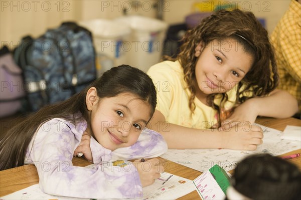 School girls writing at desks