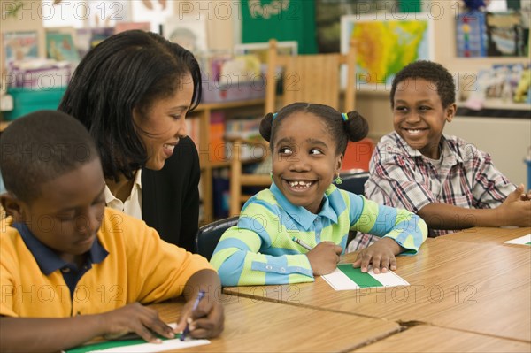 African school teacher helping students