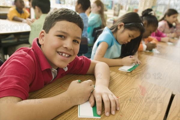 Hispanic school boy making name card