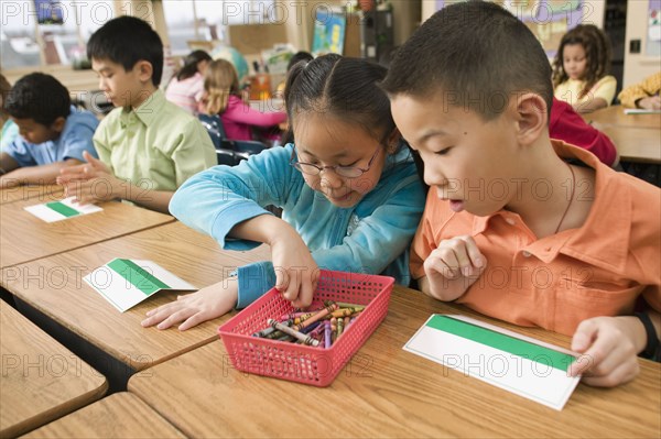 Asian school children making name cards