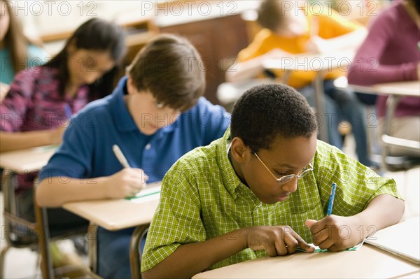 Students making name cards in classroom