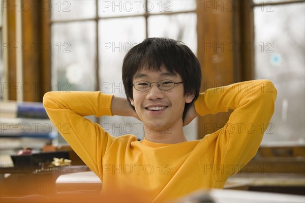 Asian student relaxing in classroom