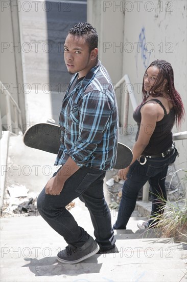 Teenagers holding skateboards on urban stairs