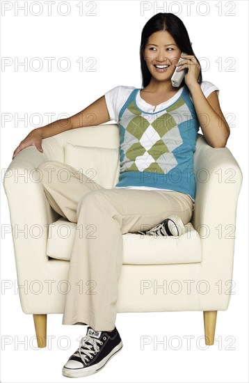 Woman sitting in chair talking on telephone