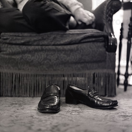 Man's shoes on floor in living room