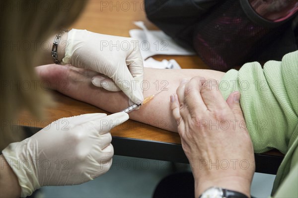 Close up of nurse giving patient injection
