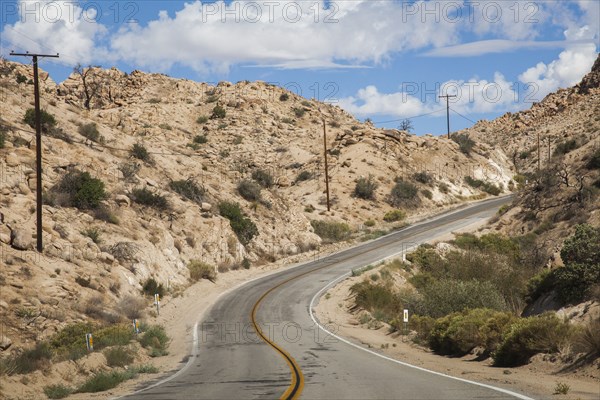Empty road on rural desert hillside