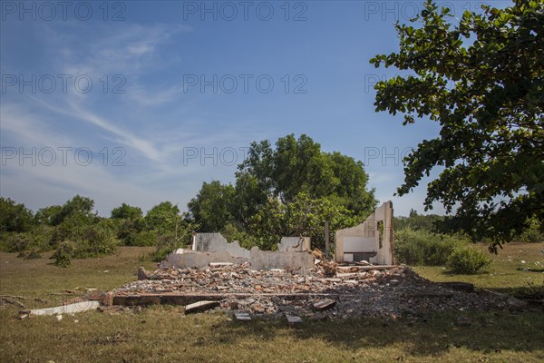 Rubble of demolished building in rural field