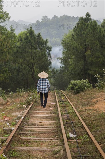 Woman walking on steps on rural hillside