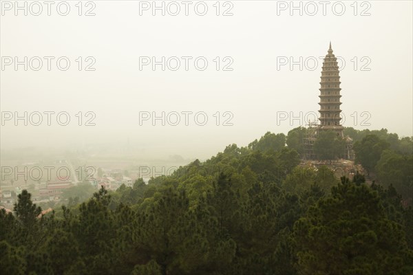 Buddhist temple tower on hilltop in remote landscape