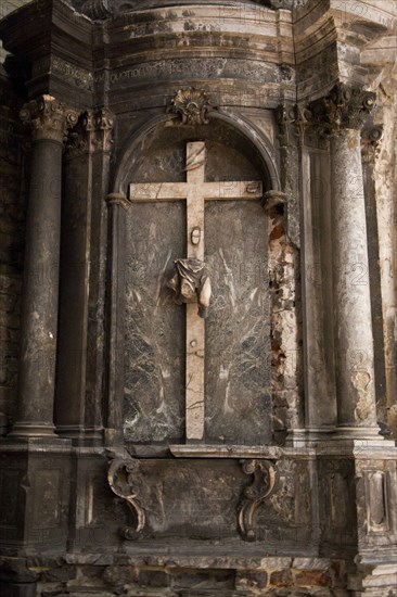 Crucifix on church wall above altar