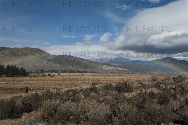 Rainbow over remote desert field