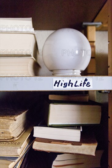 Close up of light bulb on shelf with books