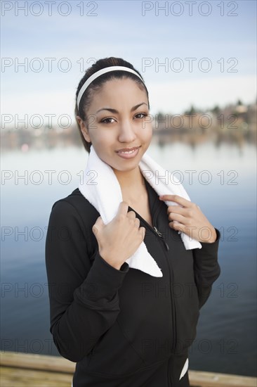 Mixed race woman with towel around neck