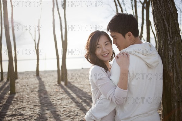 Korean couple hugging outdoors