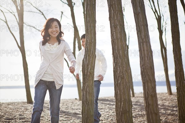 Korean couple walking on beach