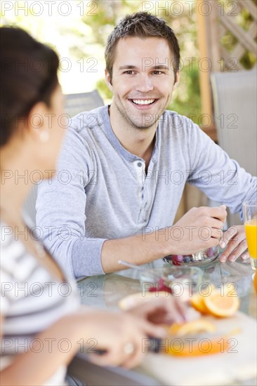 Couple eating breakfast on patio