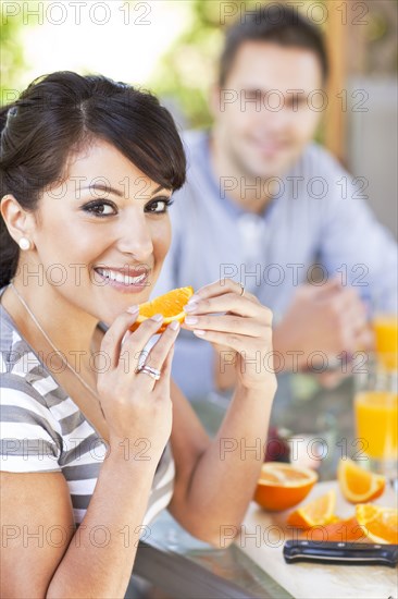 Couple eating breakfast on patio