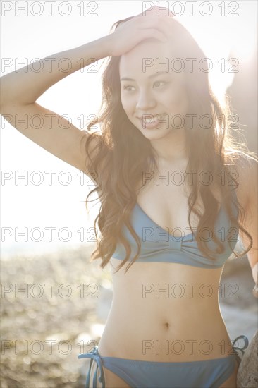 Chinese woman on beach in bikini