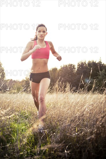 Jogger running through field