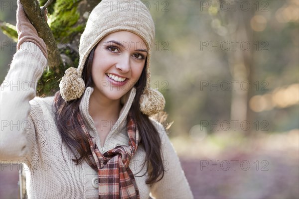 Mixed race woman in cap standing outdoors