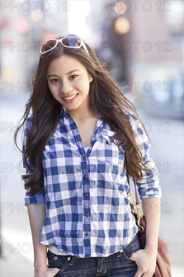 Chinese woman with hands in pockets