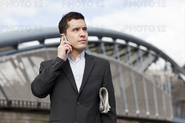 Mixed race businessman talking on cell phone