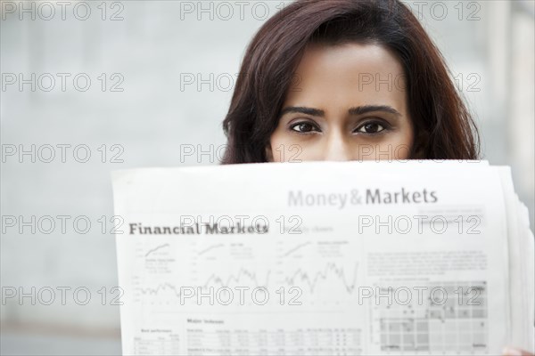 Indian woman reading newspaper