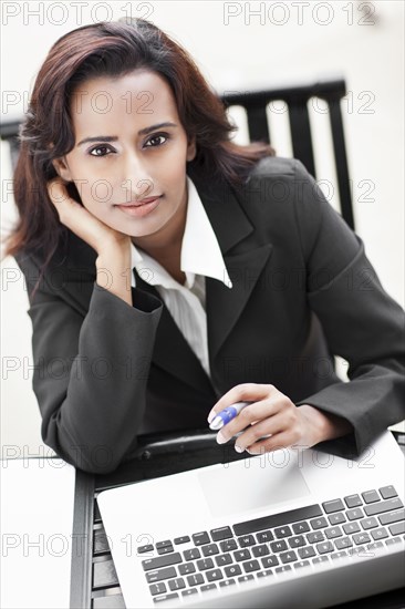 Indian businesswoman using laptop