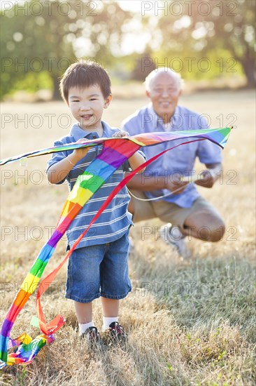 Chinese grandfather and grandson flying kite