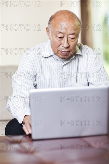 Chinese man using laptop