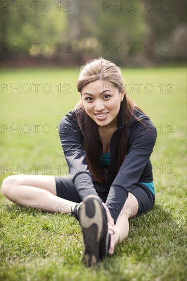 Asian woman warming up before exercise