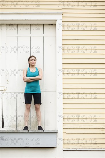 Asian woman in sportswear standing on loading dock