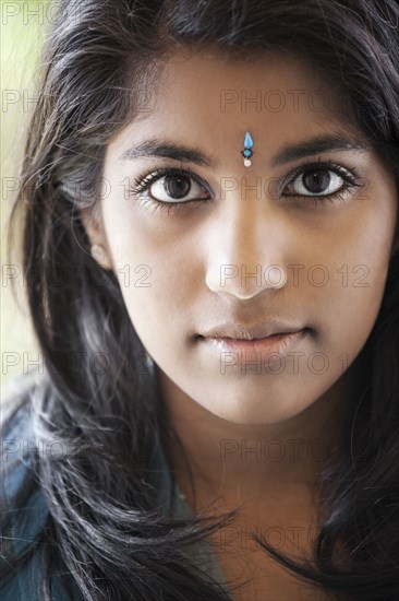 Indian woman with traditional jewel on forehead