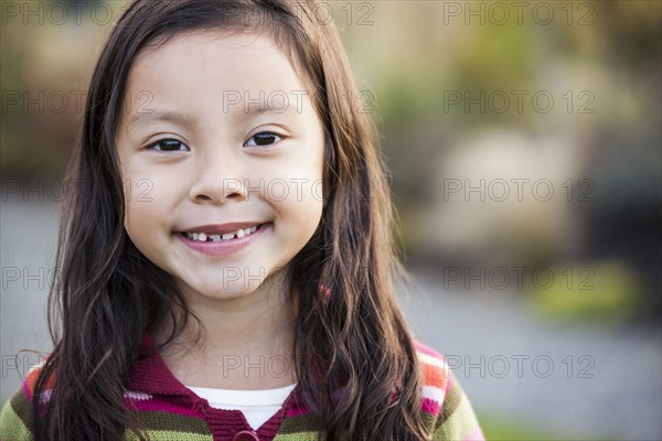 Mixed race girl smiling outdoors