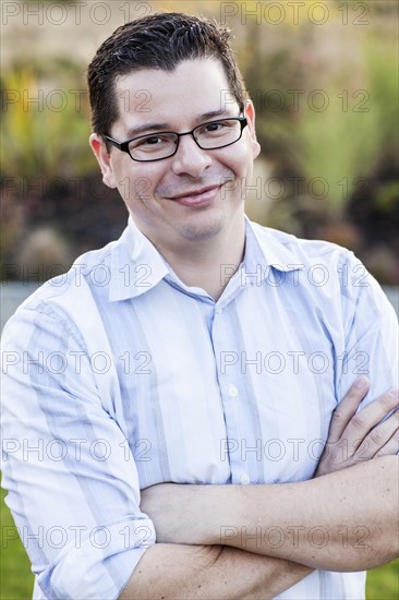 Hispanic man smiling outdoors