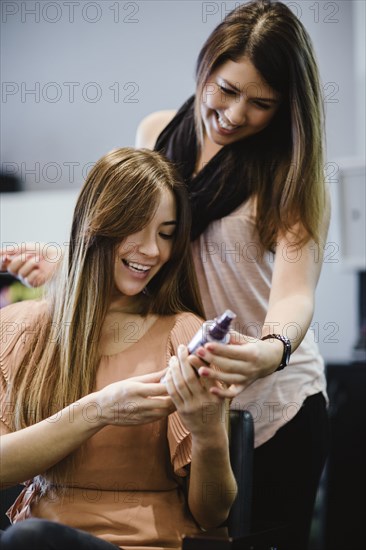 Stylist showing product to client in salon